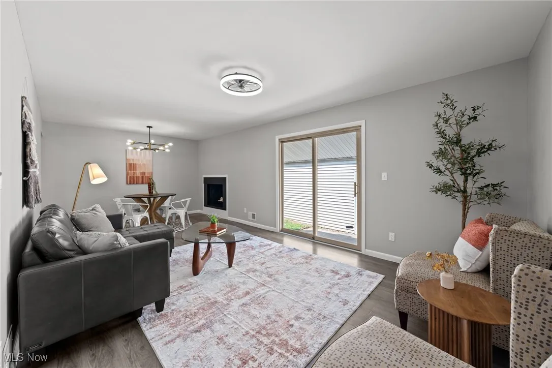 Living room featuring wood finished floors and a chandelier