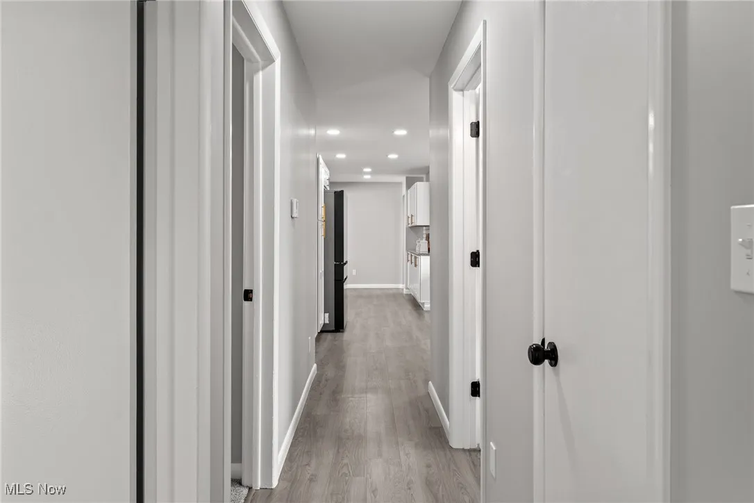 Hallway with recessed lighting and light wood-style floors
