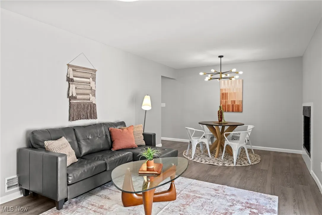 Living room featuring wood finished floors and a chandelier