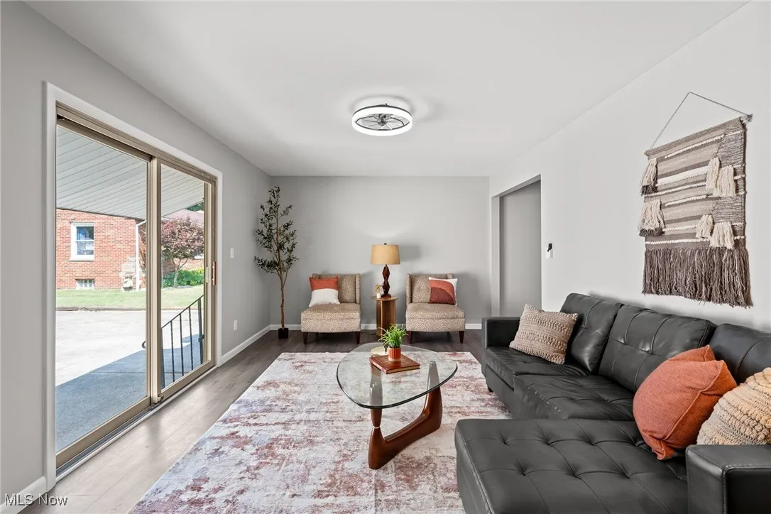 Living area with wood finished floors and baseboards