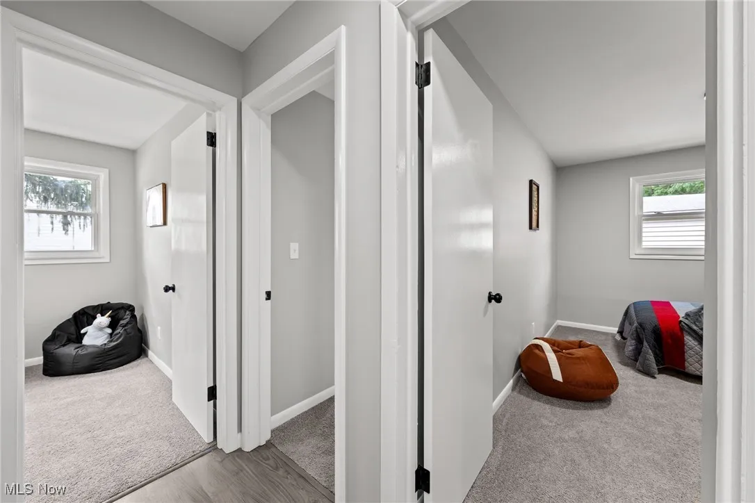 Hall featuring carpet floors and baseboards