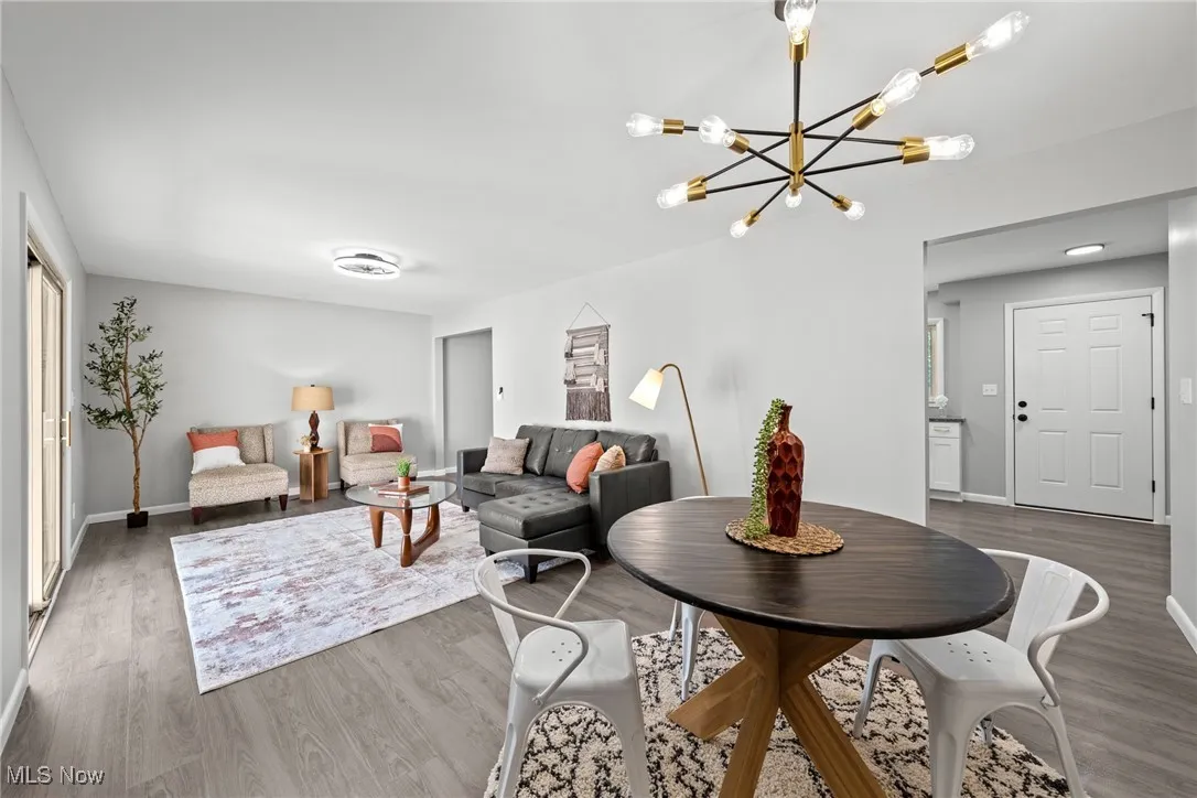 Living area featuring wood finished floors and a chandelier