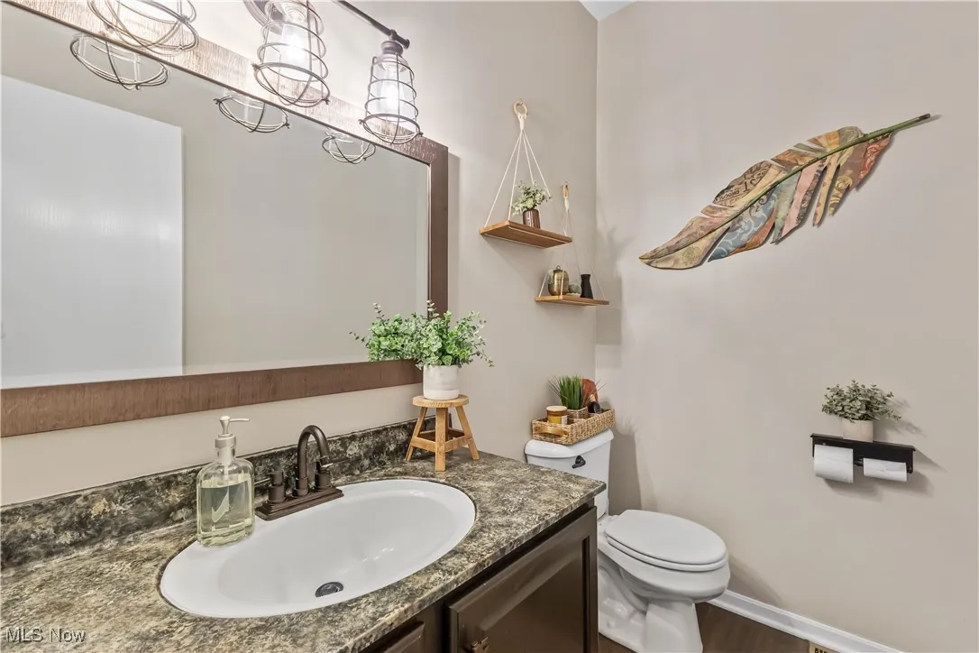 Half bathroom with vanity and a chandelier