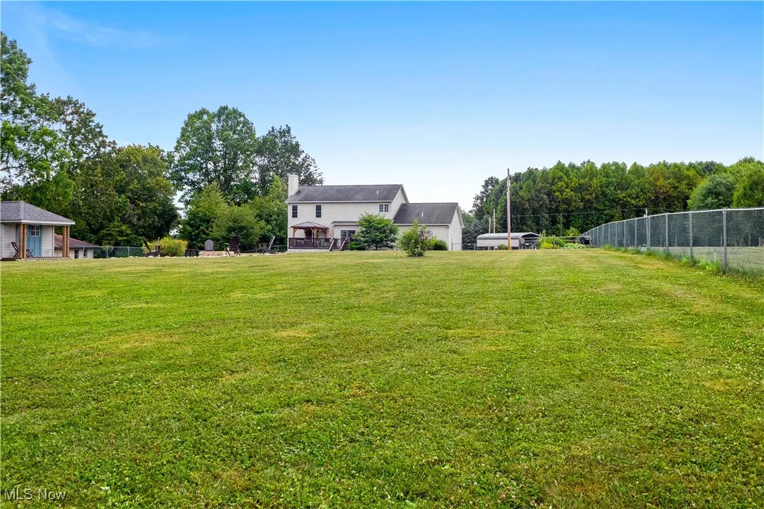 View of yard with view of wooded area