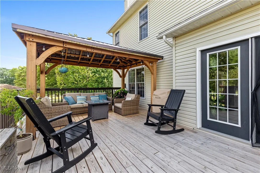 Wooden deck featuring an outdoor hangout area and a gazebo