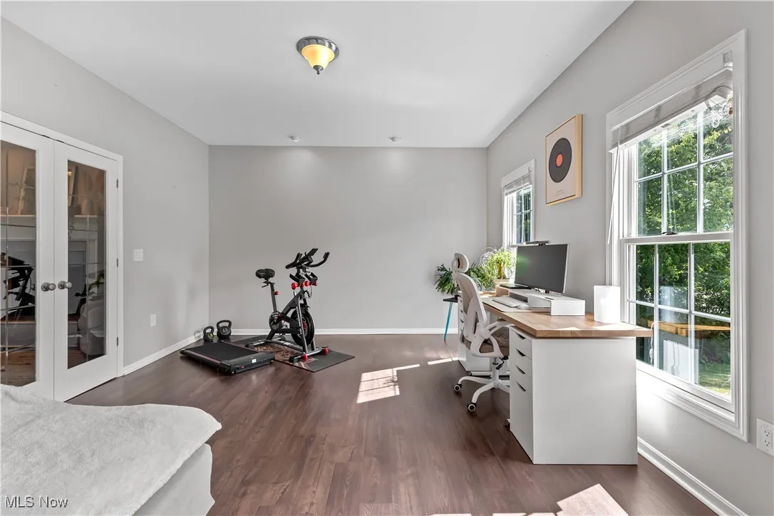 Office space with french doors and dark wood finished floors