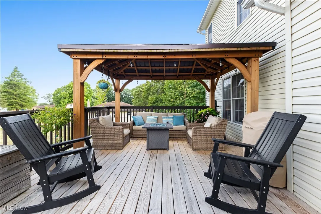 Wooden deck with an outdoor living space and a gazebo