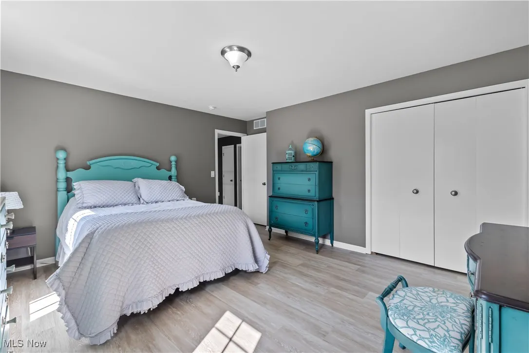 Bedroom with a closet and wood finished floors