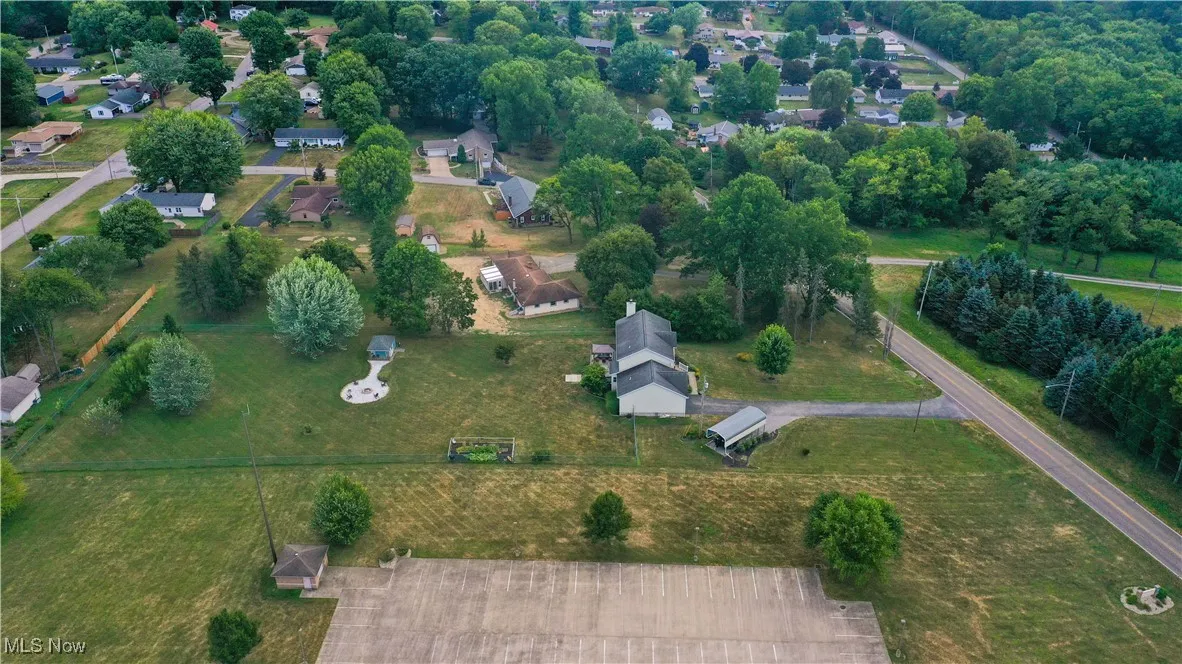 Aerial overview of property's location featuring nearby suburban area