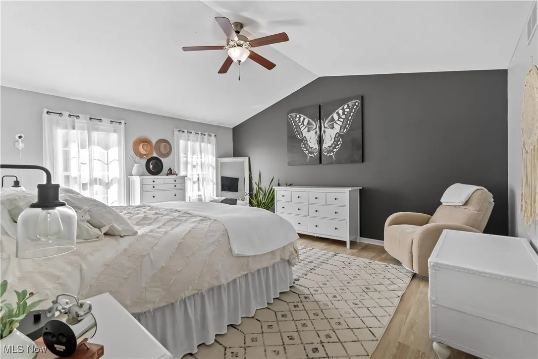 Bedroom featuring wood finished floors, lofted ceiling, and ceiling fan