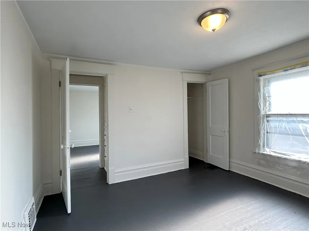 Unfurnished bedroom with a closet and baseboards