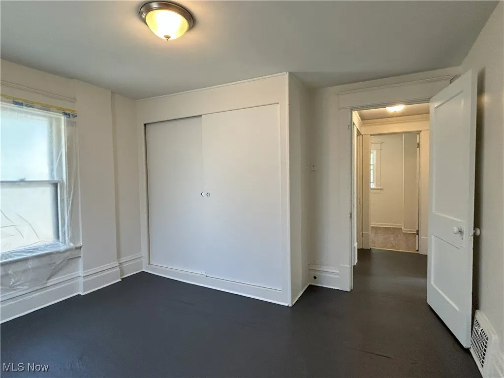 Unfurnished bedroom with a closet and baseboards