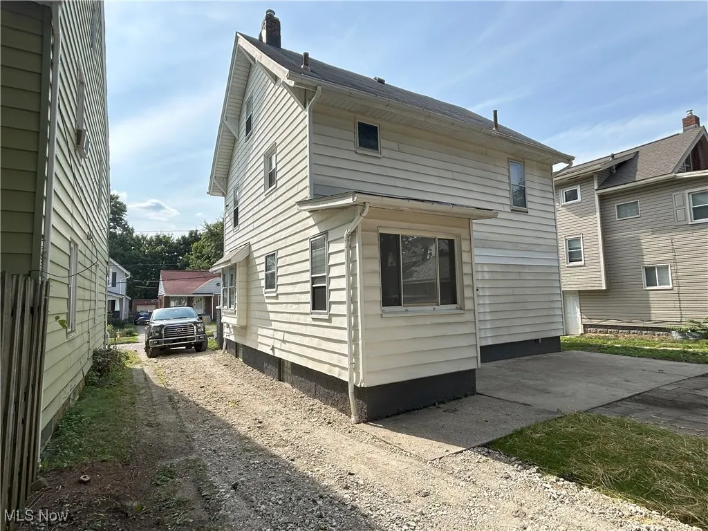 View of side of home with dirt driveway