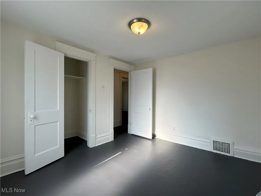 Unfurnished bedroom with baseboards and a closet