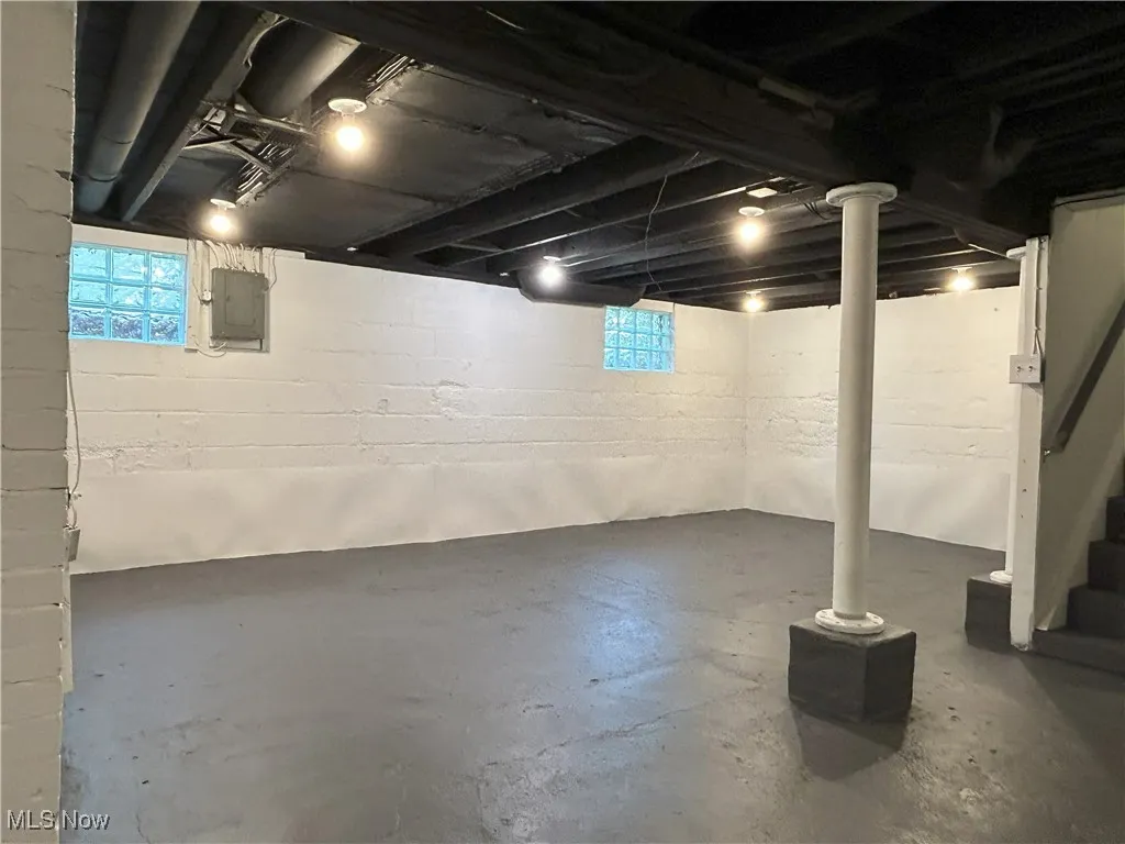 Below grade area featuring stairs and electric panel