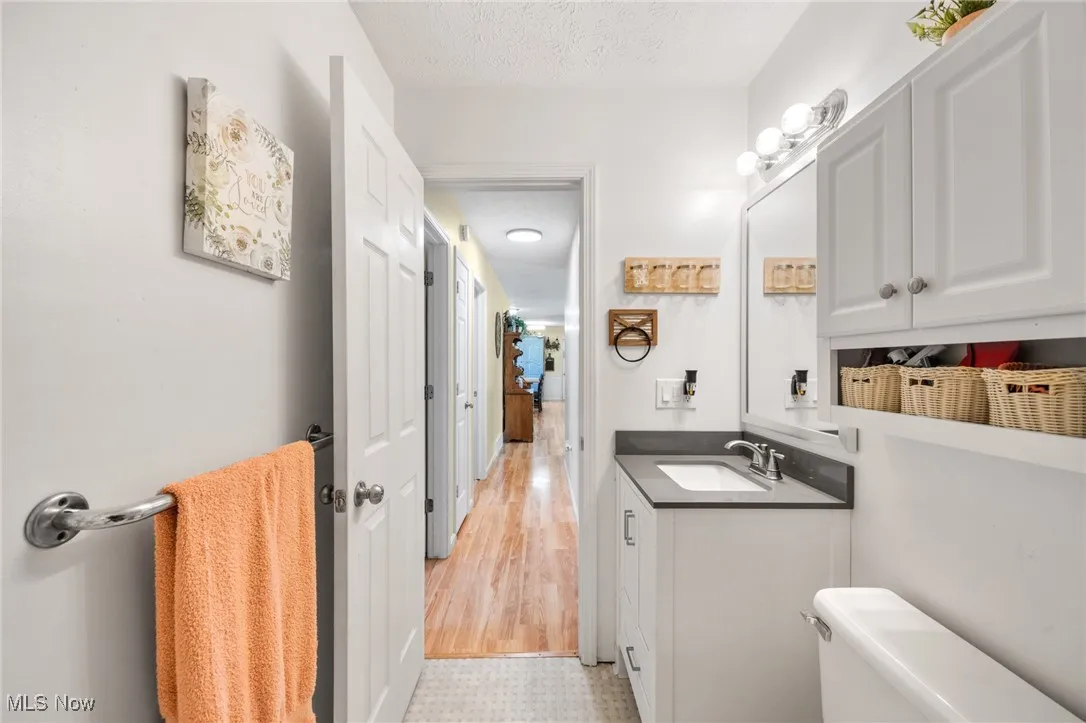 Bathroom featuring vanity and a textured ceiling