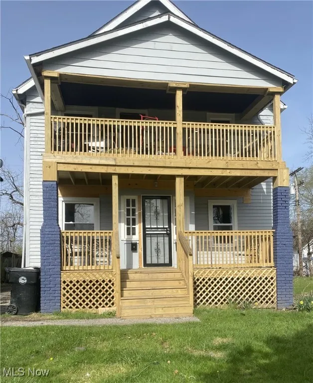 View of front of property with a porch and a front yard