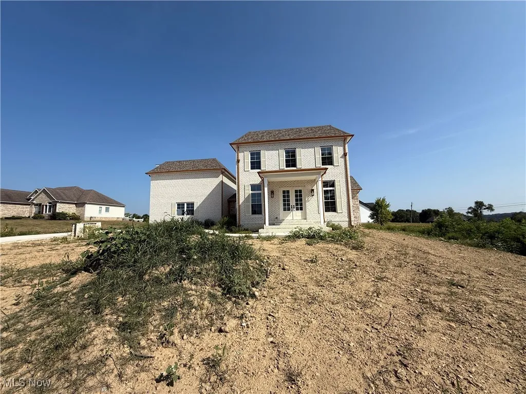 View of front of house with covered porch and brick siding
