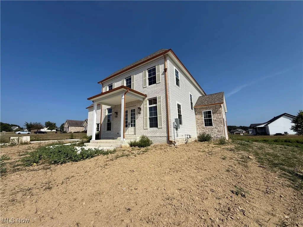 View of front of property with a porch and brick siding