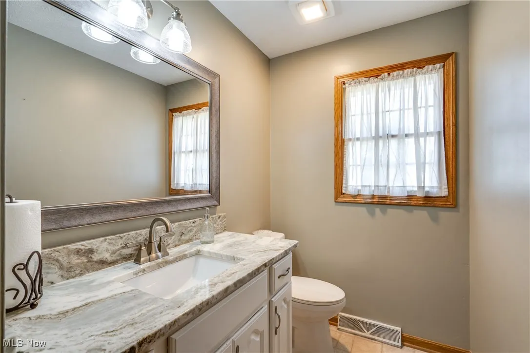Bathroom with vanity and light tile patterned floors