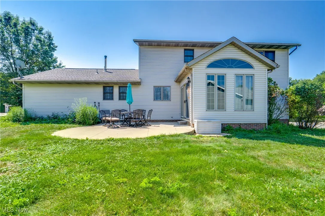Back of house featuring a patio and a lawn