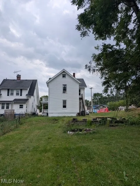 Back of property featuring stairway