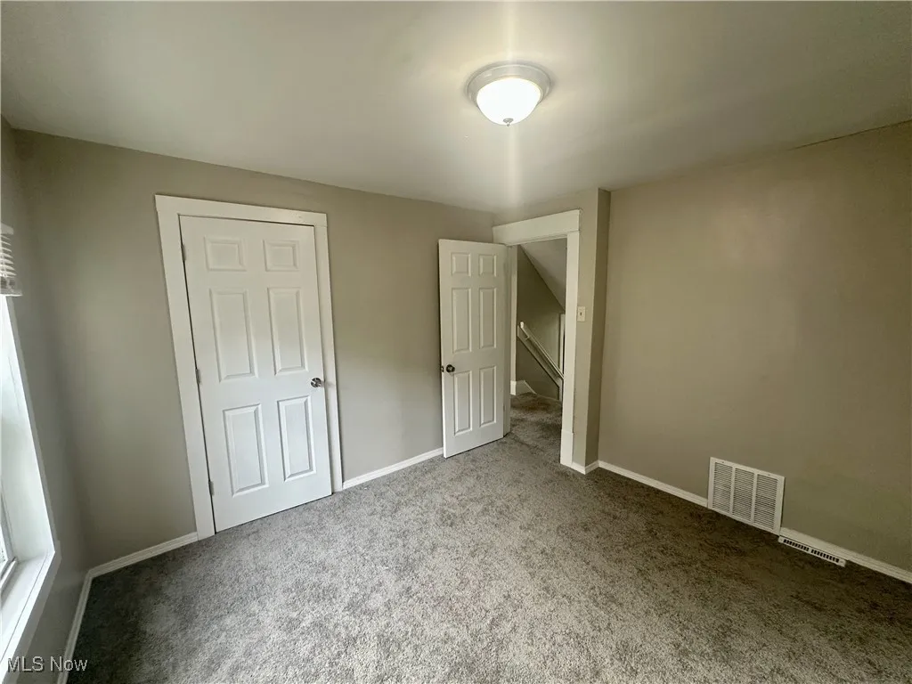 Unfurnished bedroom featuring carpet flooring and baseboards