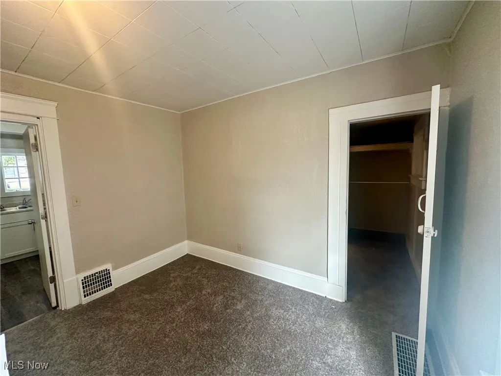Unfurnished room with baseboards