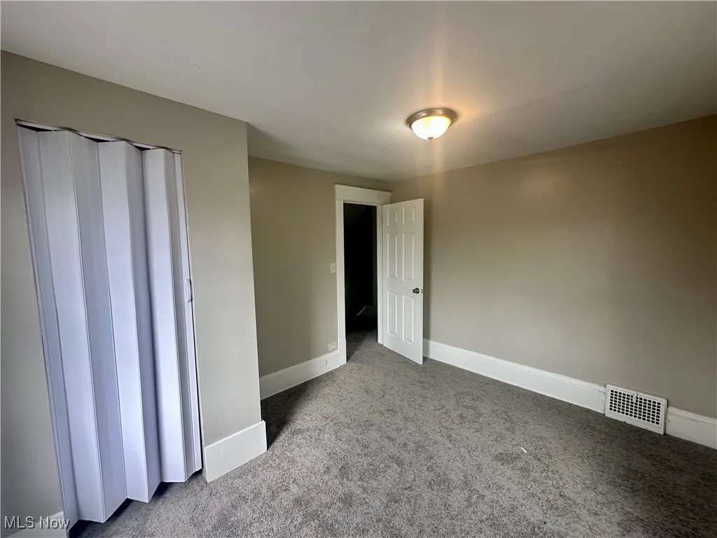 Unfurnished bedroom featuring carpet floors and a closet
