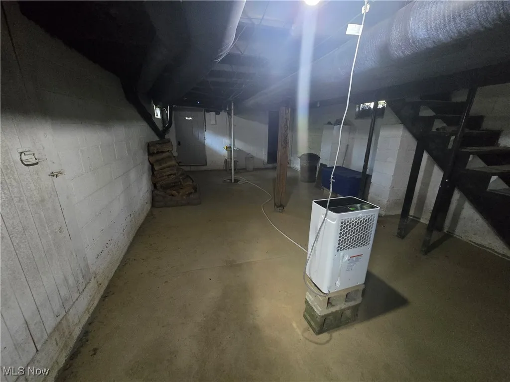 Unfinished basement with stairway