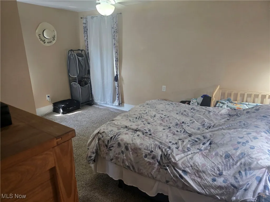 Bedroom with carpet and ceiling fan