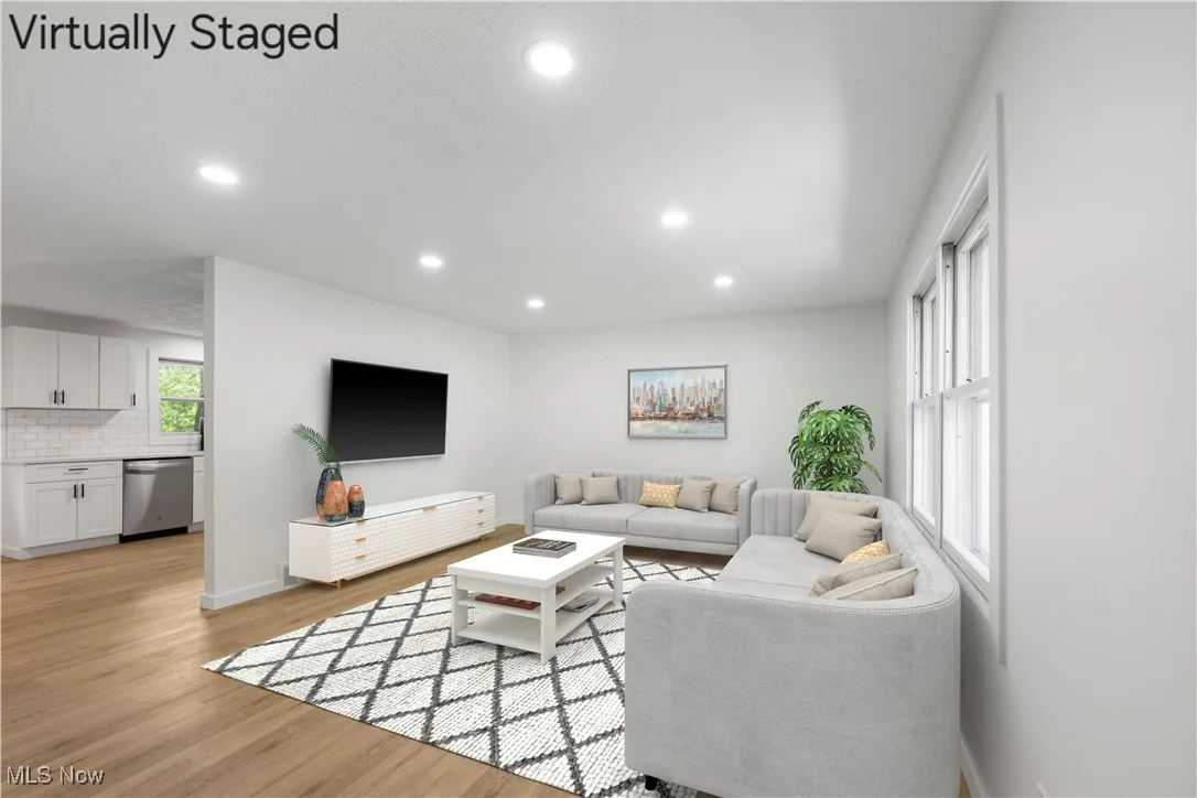 Living room with recessed lighting and light wood-type flooring