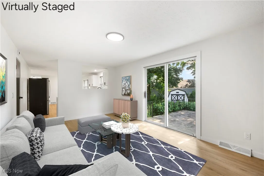 Living room featuring light wood-style flooring and baseboards
