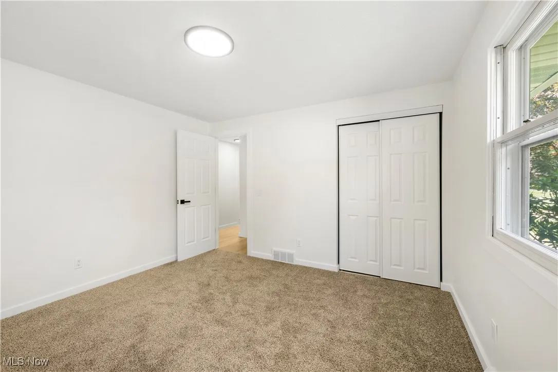 Unfurnished bedroom featuring a closet and carpet