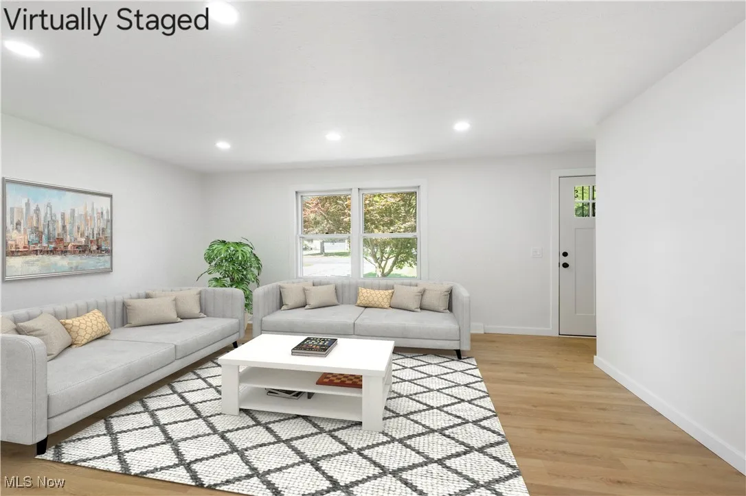Living room featuring light wood-style flooring and recessed lighting