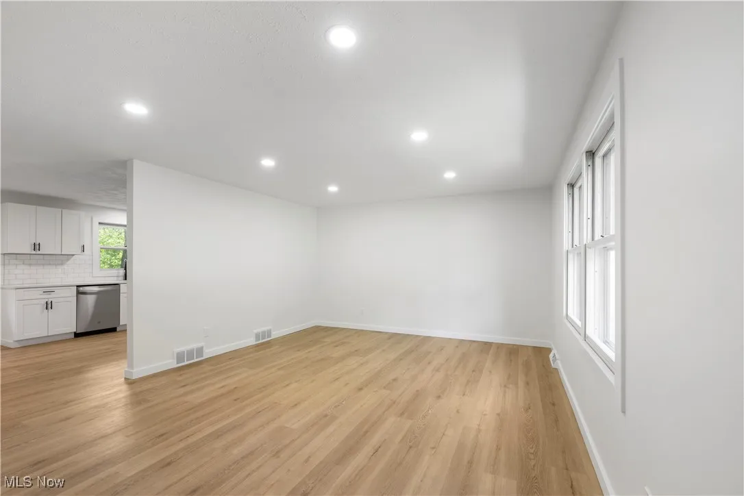Unfurnished living room with recessed lighting and light wood finished floors