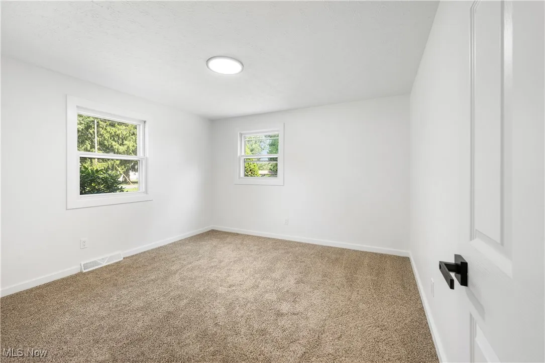 Empty room featuring carpet floors and a textured ceiling