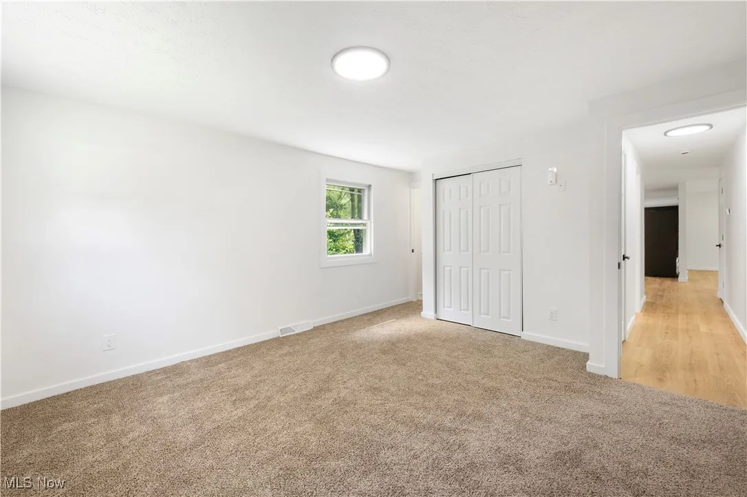 Unfurnished bedroom with a closet and carpet