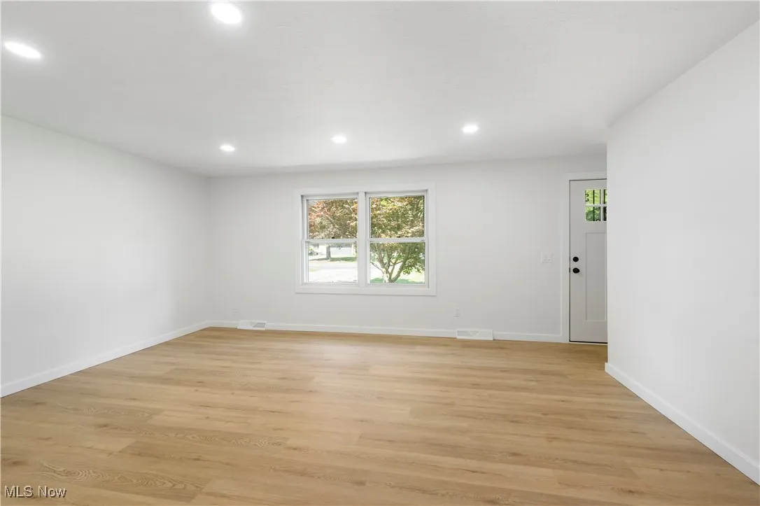 Spare room featuring light wood-style floors and recessed lighting