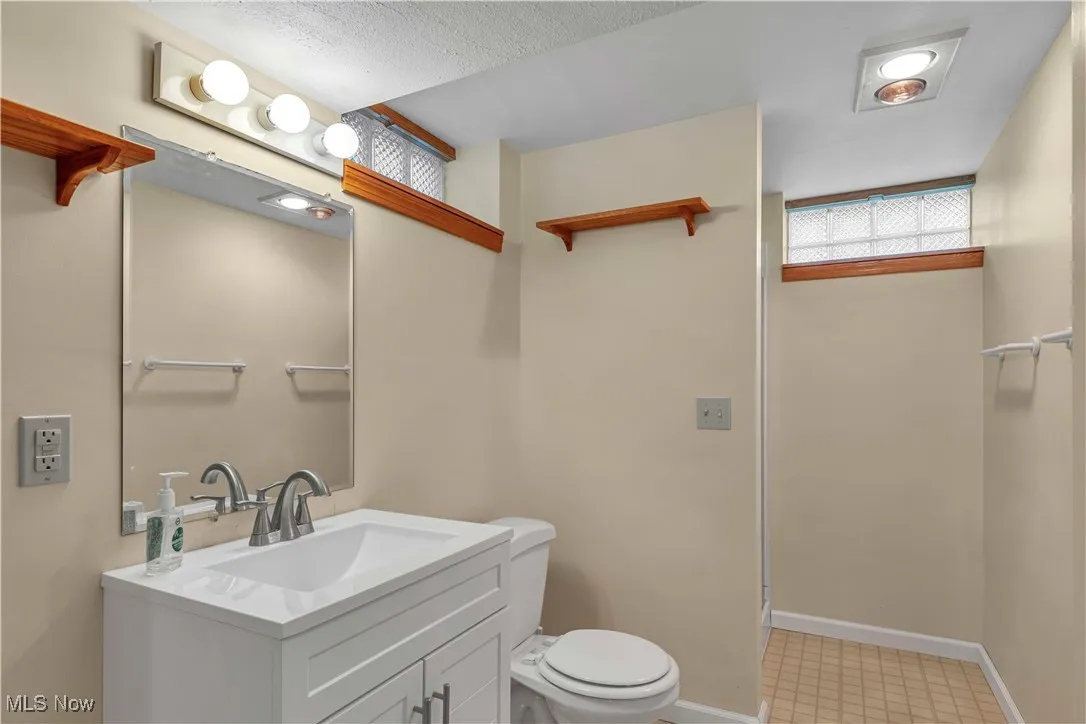 Bathroom located in the basement off the living area featuring walk in shower.