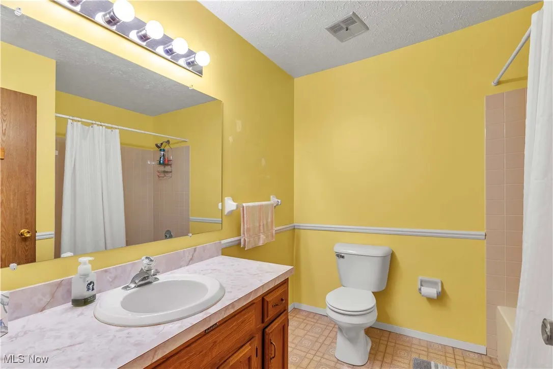 Full bathroom upstairs featuring large vanity, large mirror and tub/shower combo.