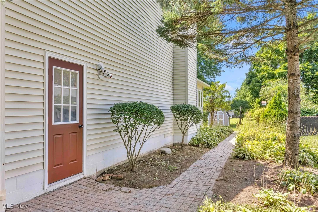 View of a beautifully landscaped walkway from back yard to the garage.