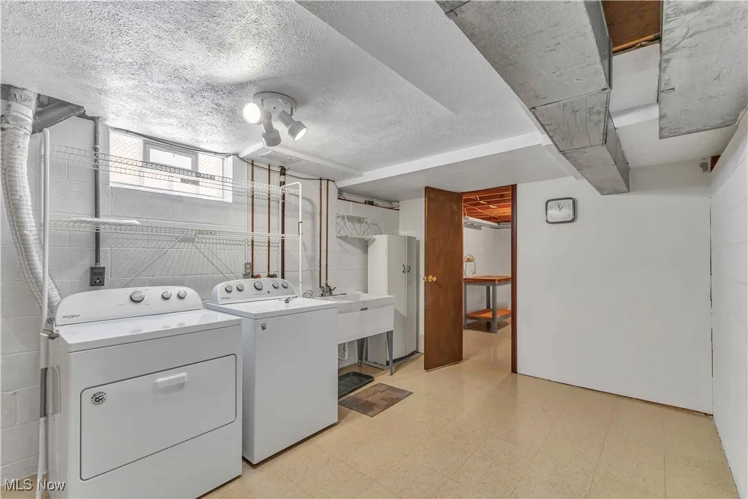 Laundry area in basement with utility sink