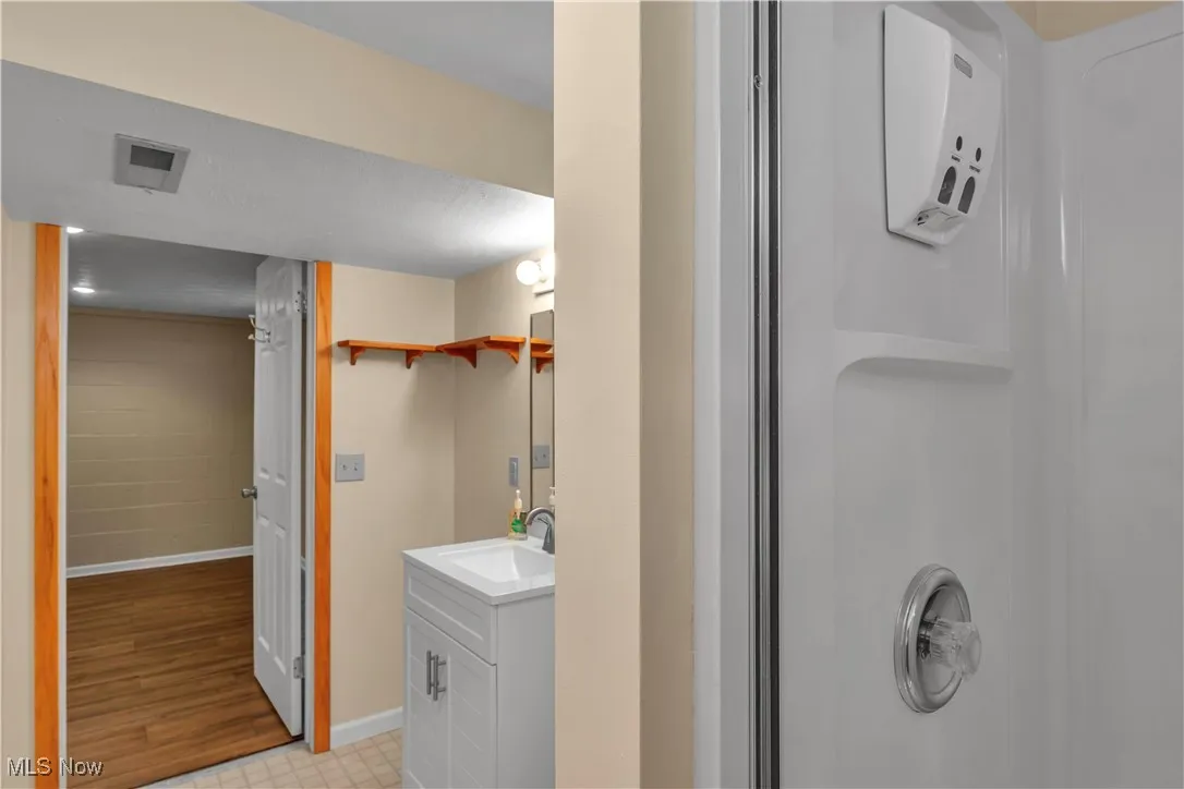 Full bath featuring vanity and a walk in shower