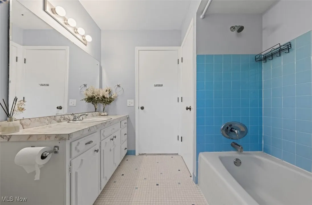 Full bath with shower / bath combination and vanity