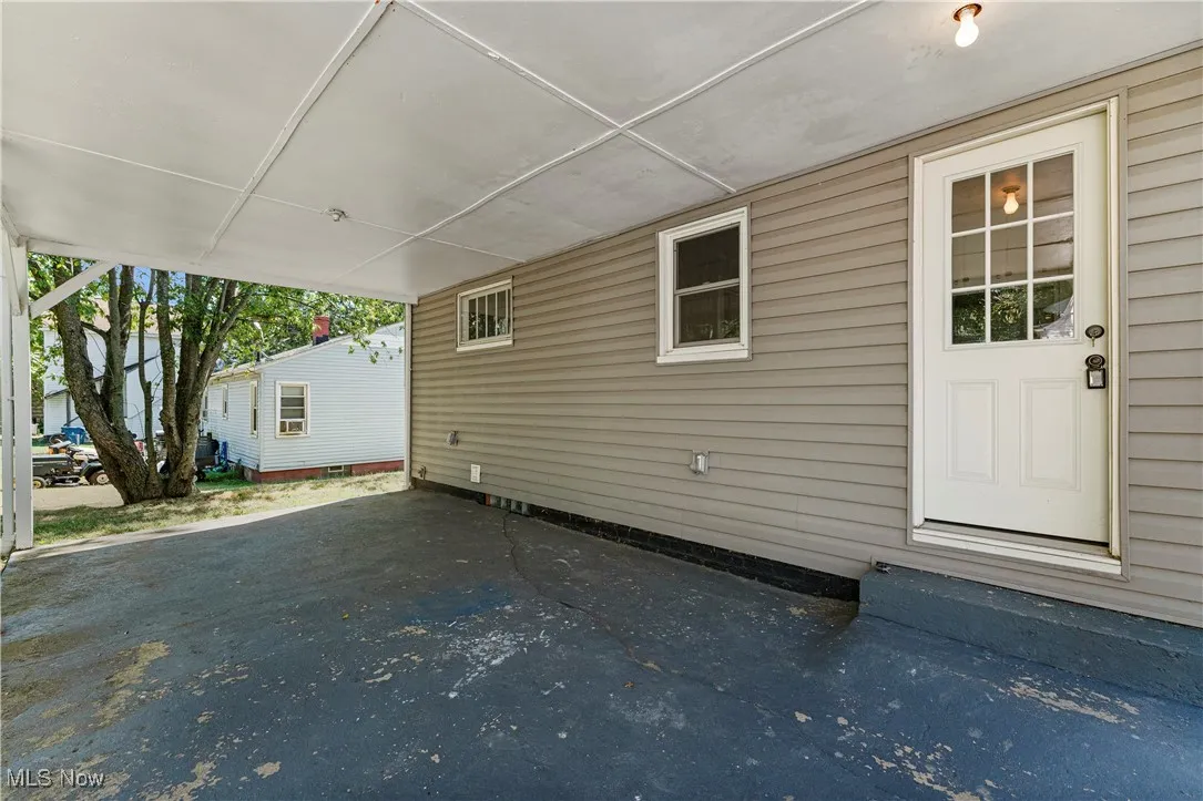 View of home's exterior with an attached carport and a patio