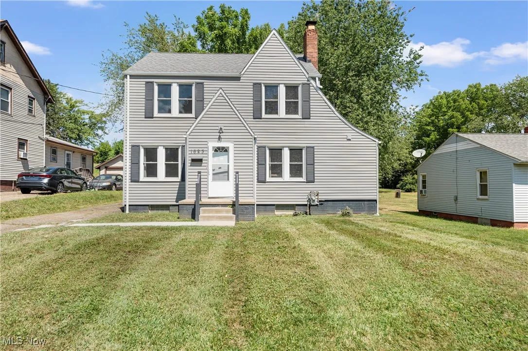 View of front of home featuring a front yard and a chimney