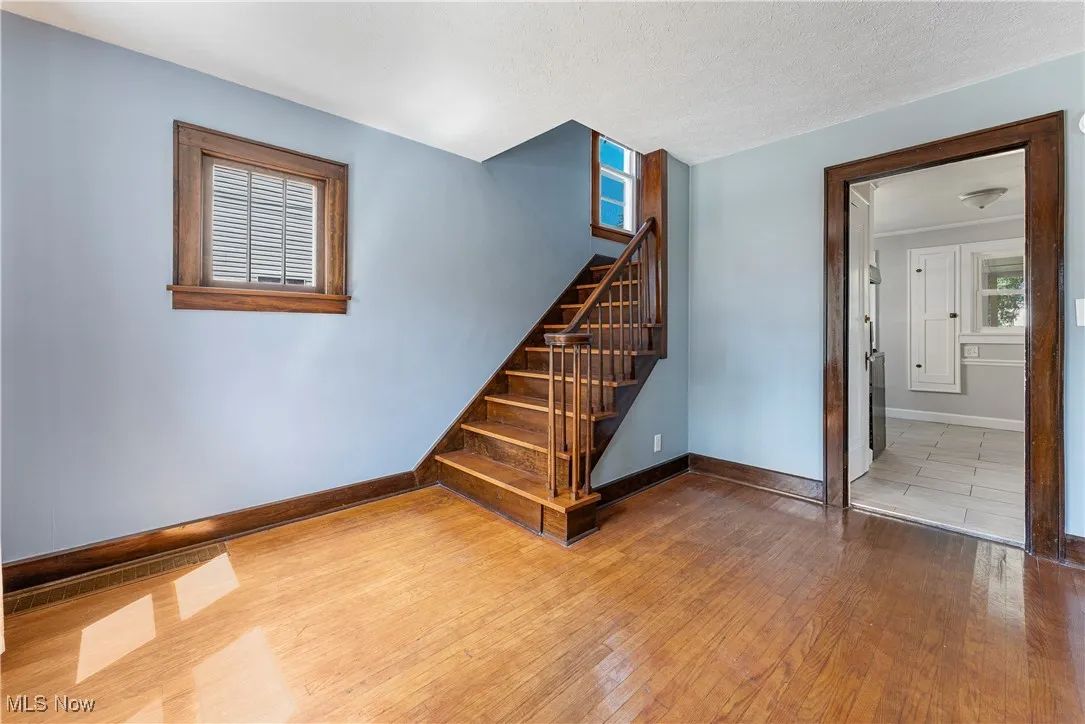 Stairs featuring hardwood / wood-style flooring and a textured ceiling