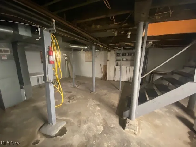 Unfinished basement featuring stairs