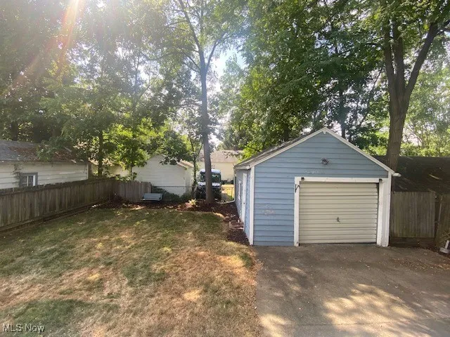 Detached garage with concrete driveway